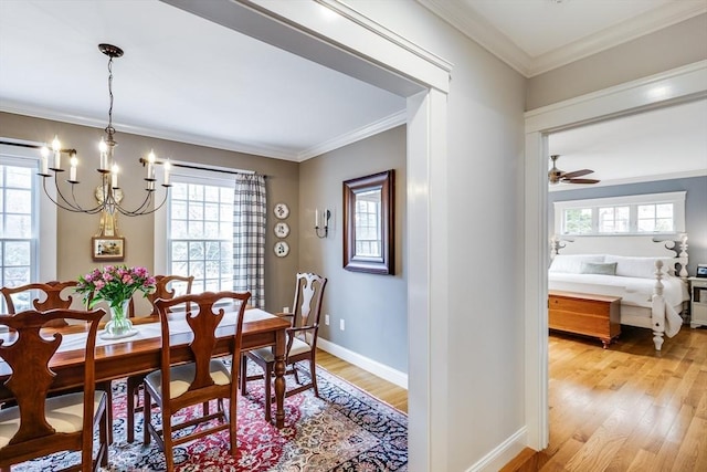 dining area featuring light wood-style floors, plenty of natural light, and ornamental molding