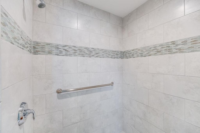 interior details with a tile shower