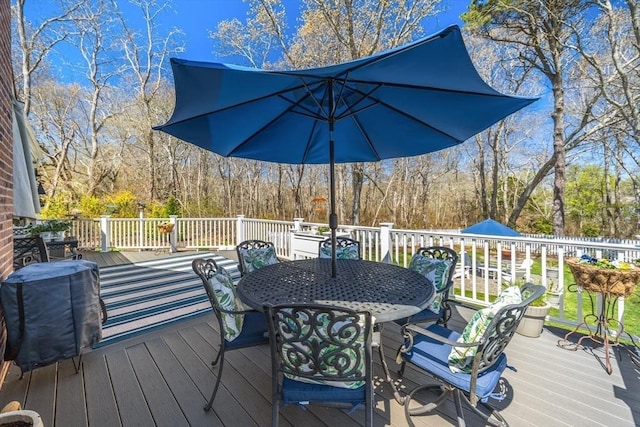 wooden deck featuring outdoor dining space