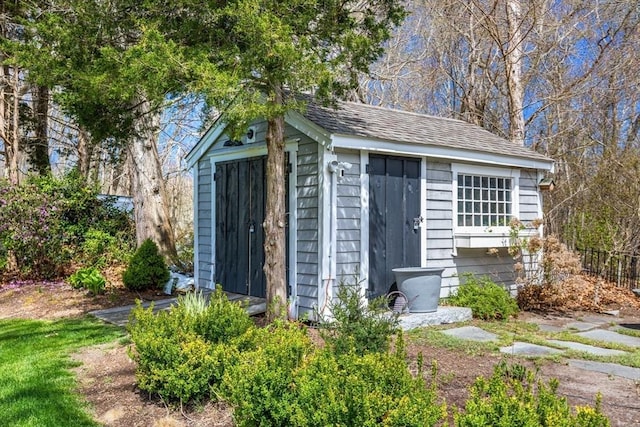 view of shed featuring fence