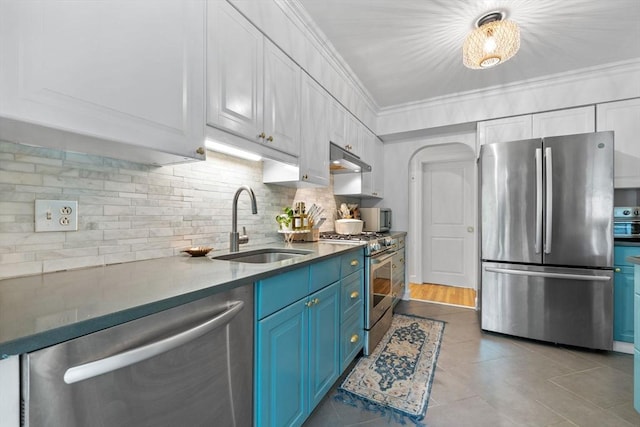 2313 Washington St, Holliston, MA 01746 - kitchen with stainless steel appliances, blue cabinetry, a sink, tasteful backsplash, and light tile patterned floors