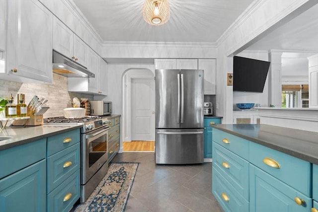 2313 Washington St, Holliston, MA 01746 - kitchen with appliances with stainless steel finishes, under cabinet range hood, blue cabinets, decorative backsplash, and dark tile patterned floors