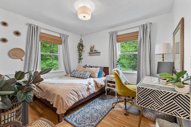 2313 Washington St, Holliston, MA 01746 - bedroom with wood finished floors, multiple windows, and a desk