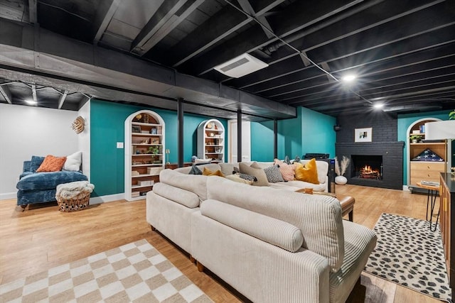 2313 Washington St, Holliston, MA 01746 - living room with a fireplace, wood finished floors, and baseboards