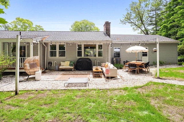 2313 Washington St, Holliston, MA 01746 - rear view of house with a patio area, a chimney, a shingled roof, and a lawn