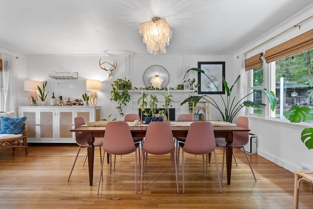2313 Washington St, Holliston, MA 01746 - dining area featuring wood finished floors, a chandelier, and baseboards
