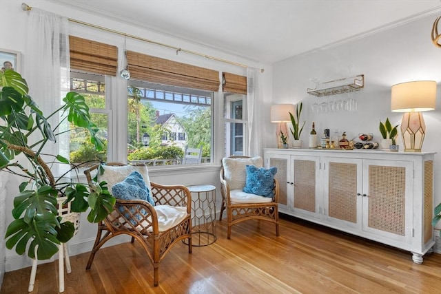 2313 Washington St, Holliston, MA 01746 - sitting room with wood finished floors, a bar, and ornamental molding