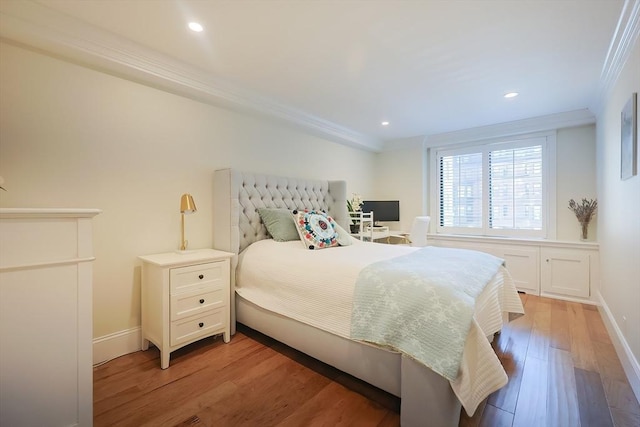 bedroom with ornamental molding and light hardwood / wood-style flooring