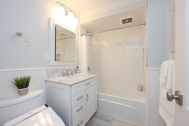 full bathroom with vanity, toilet, tile walls, and shower / tub combo