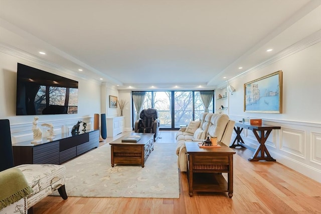 living room featuring light hardwood / wood-style floors and ornamental molding