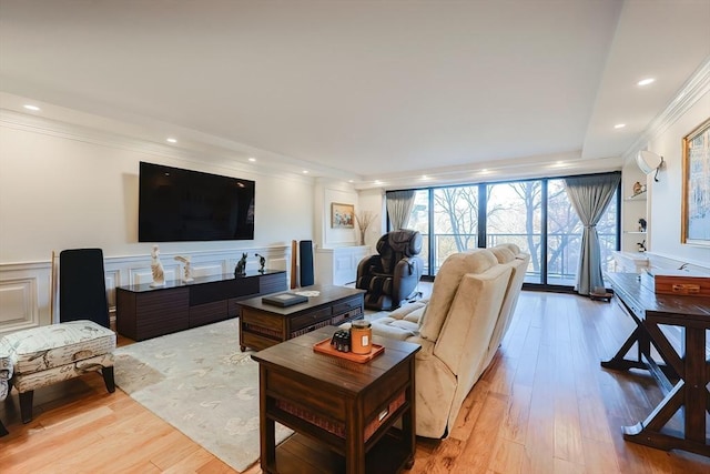 living room with light hardwood / wood-style floors and ornamental molding