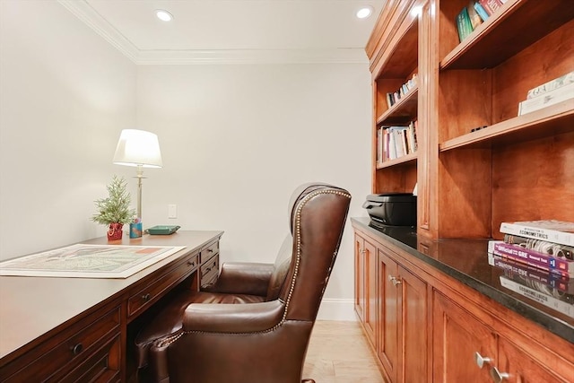 office space with built in desk and crown molding