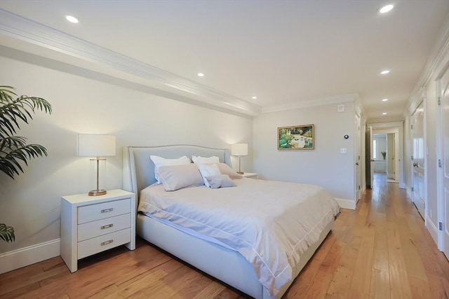 bedroom featuring light hardwood / wood-style floors and ornamental molding