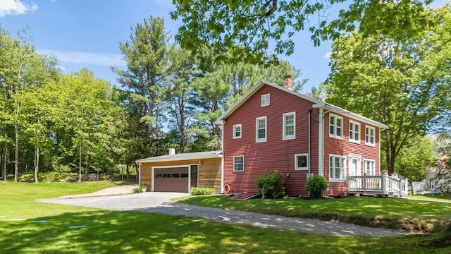 8 Intervale Rd, Rutland, MA 01543 - view of side of home featuring a chimney, driveway, an attached garage, a lawn, and a deck