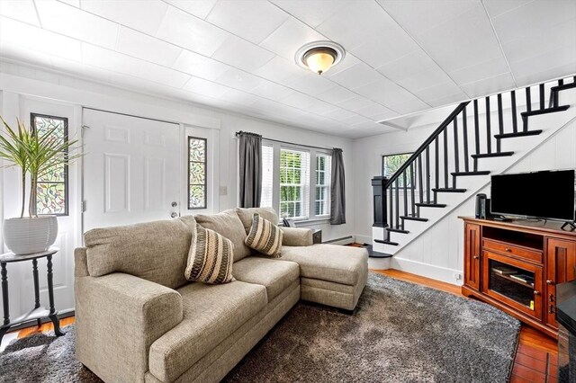 8 Intervale Rd, Rutland, MA 01543 - living area with wood finished floors, stairs, and a baseboard heating unit