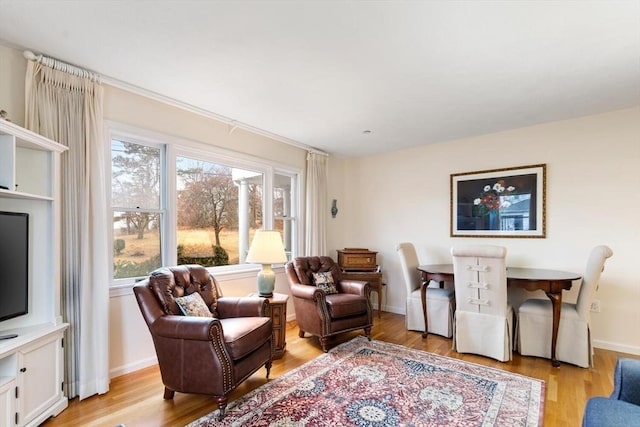 sitting room featuring light wood-type flooring and baseboards