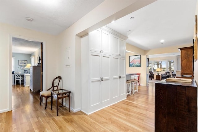 hallway featuring light wood-style floors, recessed lighting, and baseboards