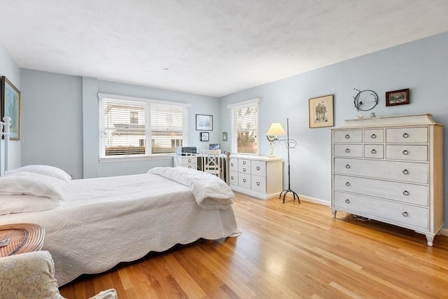 bedroom featuring light wood-type flooring and baseboards