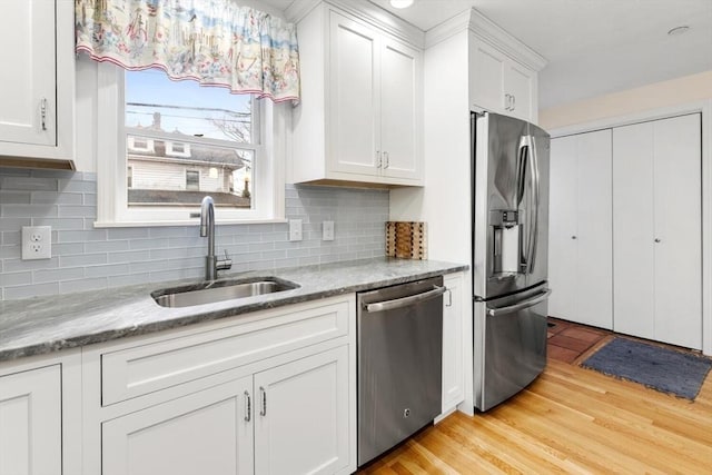 kitchen with light wood-style floors, white cabinetry, appliances with stainless steel finishes, and a sink