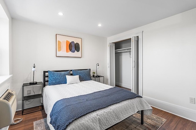 bedroom with a closet, recessed lighting, baseboards, and wood finished floors