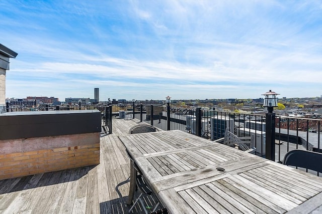 deck featuring a view of city and outdoor dining area