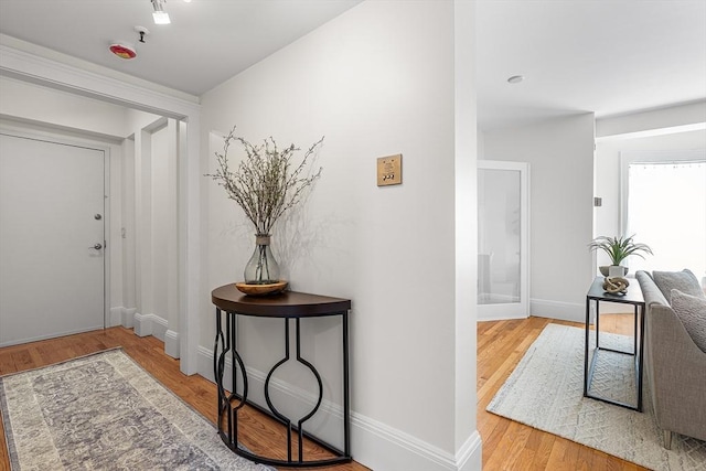foyer featuring baseboards and wood finished floors
