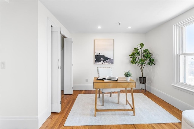 office space featuring light wood-type flooring, recessed lighting, and baseboards