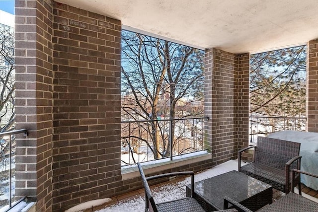 view of snow covered back of property