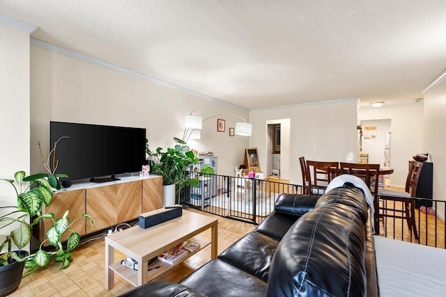 living room with light parquet flooring, a textured ceiling, and crown molding