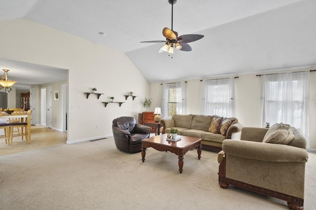 living room with light colored carpet, a ceiling fan, vaulted ceiling, and visible vents