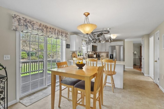 dining room featuring baseboards and an inviting chandelier