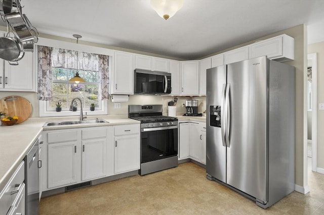 kitchen with visible vents, a sink, white cabinetry, and stainless steel appliances
