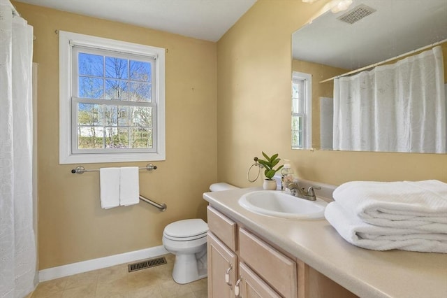 bathroom featuring a healthy amount of sunlight, baseboards, and visible vents