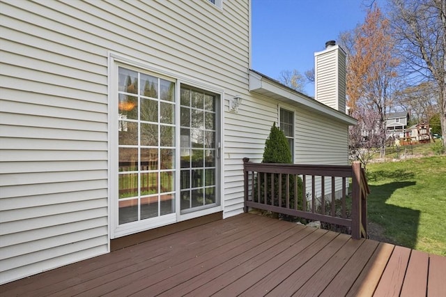 wooden terrace featuring a yard