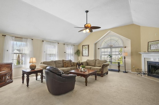 carpeted living area featuring baseboards, a ceiling fan, and vaulted ceiling
