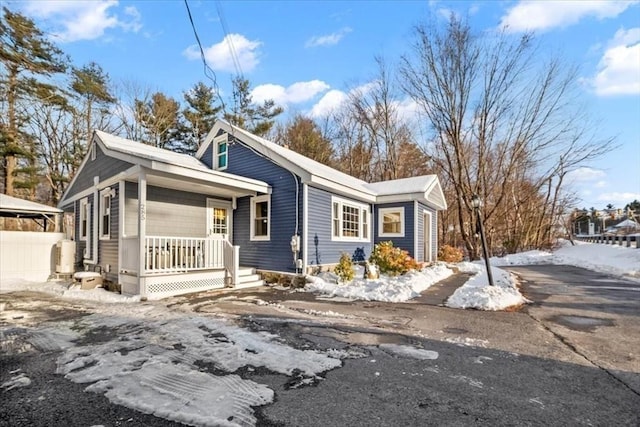 view of snowy exterior with covered porch