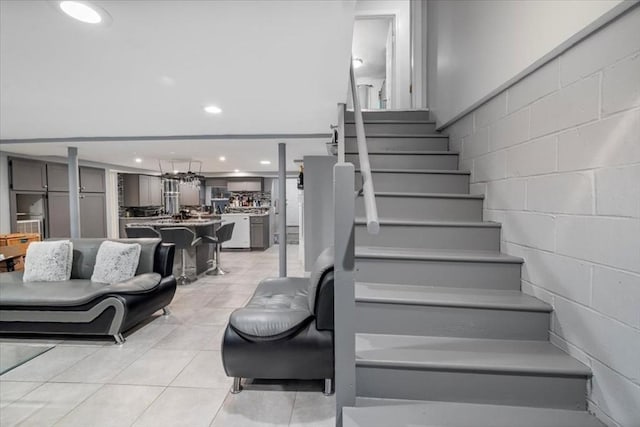 staircase featuring tile patterned flooring