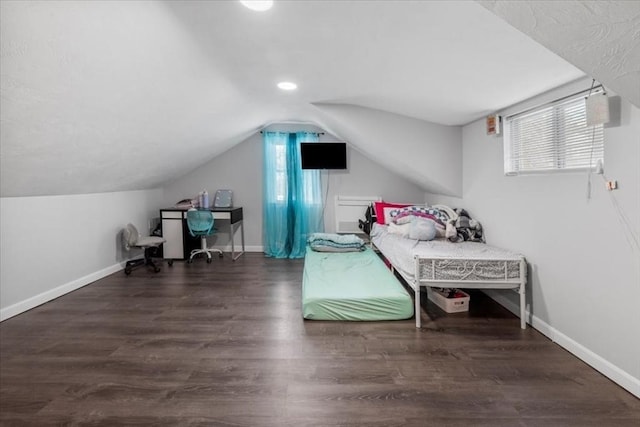 bedroom with vaulted ceiling and dark wood-type flooring