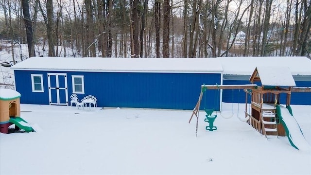 snow covered structure with a playground