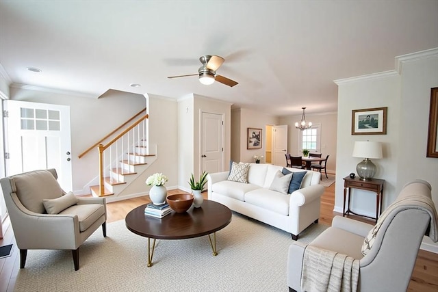 27 Williams St Unit 27, Methuen, MA 01844 - living room with light wood-style flooring, stairway, crown molding, a chandelier, and a ceiling fan