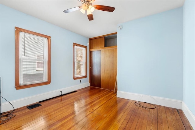 unfurnished bedroom with baseboards, visible vents, and light wood finished floors