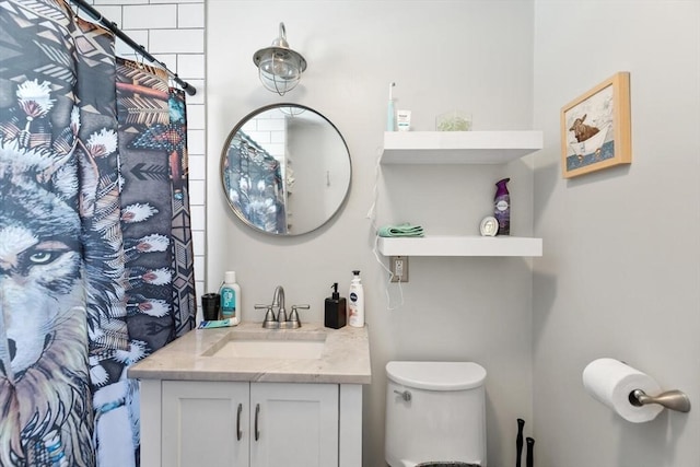 full bath featuring vanity and toilet