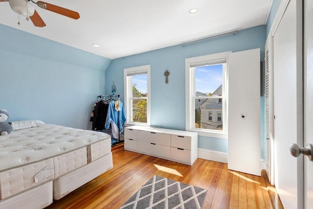 bedroom with recessed lighting, light wood-style flooring, baseboards, and vaulted ceiling
