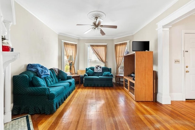 living area with a ceiling fan, ornate columns, and light wood-type flooring