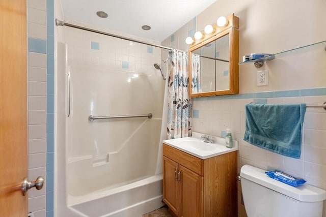 full bath with vanity, shower / tub combo with curtain, toilet, and tile walls