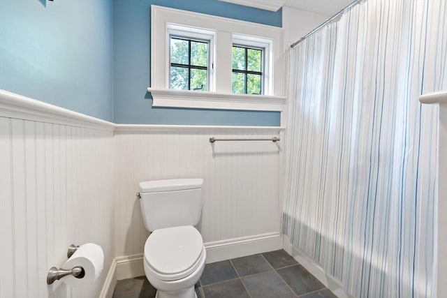 218 Pine St, Rehoboth, MA 02769 - bathroom with wainscoting, toilet, and shower / bath combination with curtain