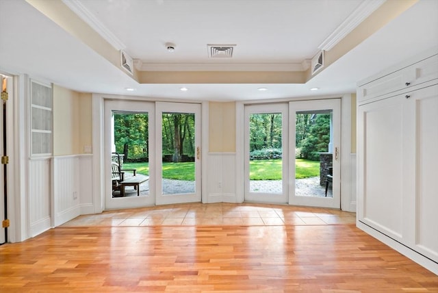 218 Pine St, Rehoboth, MA 02769 - doorway featuring ornamental molding, plenty of natural light, light wood-type flooring, a decorative wall, and a tray ceiling