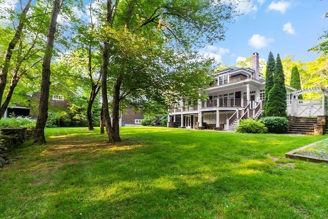 218 Pine St, Rehoboth, MA 02769 - view of green lawn with stairs and a deck