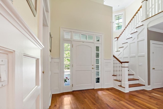 218 Pine St, Rehoboth, MA 02769 - entryway featuring a decorative wall, wood finished floors, stairs, a towering ceiling, and a wainscoted wall
