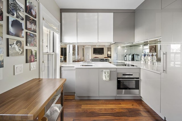 416 Commonwealth Ave Unit 317, Boston, MA 02215 - kitchen with modern cabinets, a sink, light countertops, dark wood-style floors, and oven